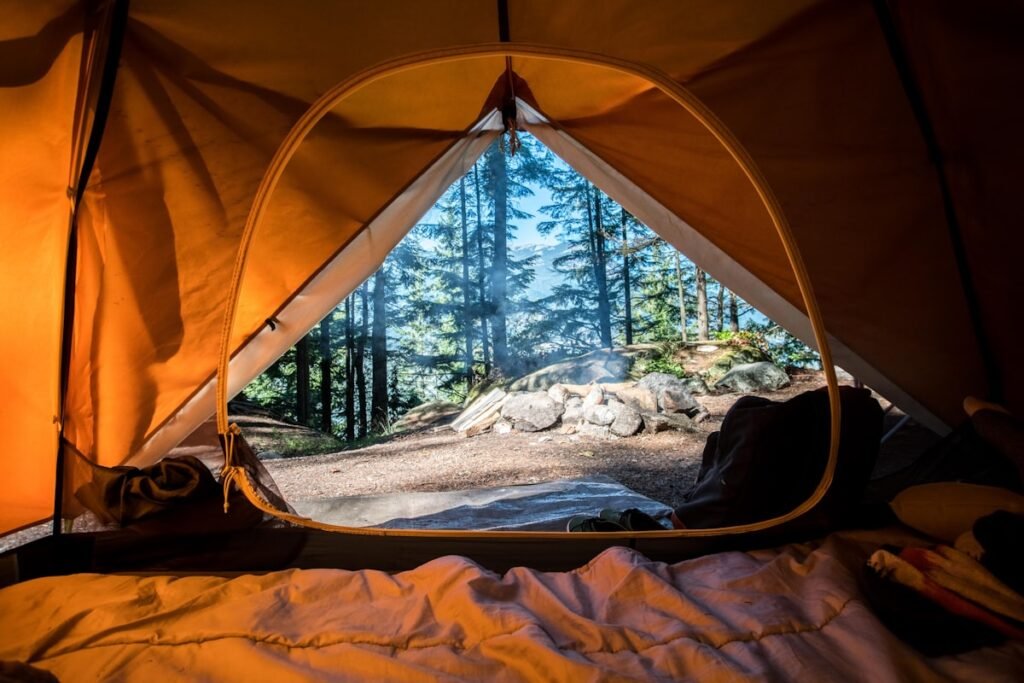 Camping tent set up in mountain landscape at sunset